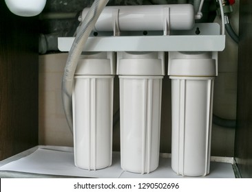  Reverse Osmosis Water Purification System At Home. Installation Of Water Purification Filters Under Kitchen Sink In Cupboard. Clear Water Concept