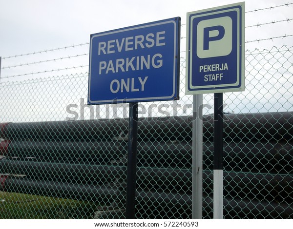 Reverse parking signage at oil and gas warehouse yard at\
staff parking lot 