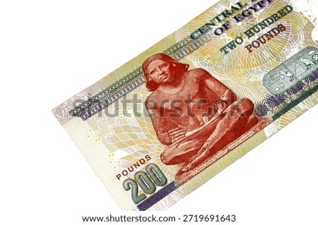 the reverse side of 200 LE EGP two hundred Egyptian pounds cash money banknote paper series 2013 features the seated scribe of ancient Egypt, selective focus of Egyptian money