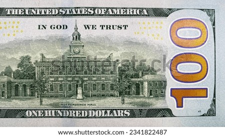 The reverse side of the bill is one hundred US dollars. In god we trust. Top view of part of the $100 bill. The American national currency. Cash banknote. Economics and finance.