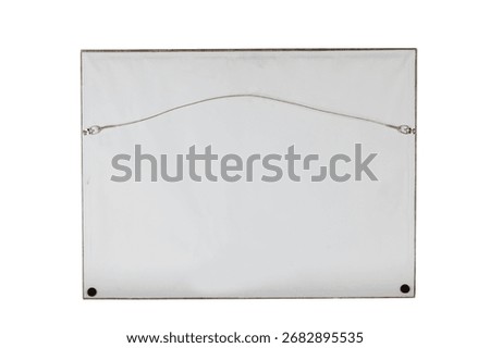 The reverse side of a framed artwork displays a white backing board with a metal hanging wire attached to D-rings screwed into the frame.