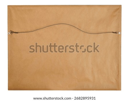The reverse side of a framed artwork is shown, covered in light brown backing paper. A thin wire is attached to two metal D-rings on the sides, creating a curved hanging mechanism.