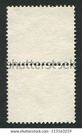 The reverse side of a postage stamp.