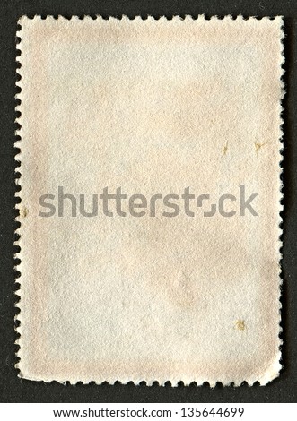 The reverse side of a postage stamp.