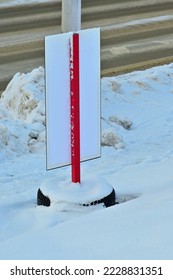 The reverse side of a temporary road sign on a winter day