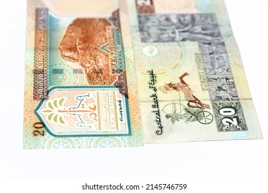 Reverse sides of Saudi Arabia 20 twenty riyals banknote with 20 LE twenty Egyptian pounds bill isolated on a white background, Selective focus of Egyptian and Saudi money exchange rate