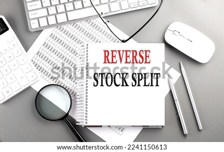 Reverse Stock Split text on notepad on chart with keyboard and calculator on a grey background