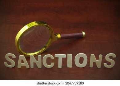 Review Sanctions Concept. Magnifying Glass And Letters Sanctions On Wooden Table. 