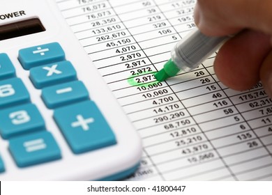 Reviewing The Accounts On A Printed Spread Sheet.