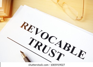 Revocable trust on a wooden desk.