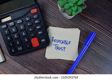 Revocable Trust write on sticky notes isolated on Wooden Table.