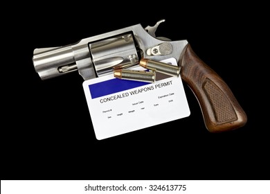 Revolver Gun With Concealed Weapon Permit Isolated On Black Background