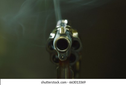  Revolver Gun Muzzle With Smoke Floating In The Air After Shoot On Black Background