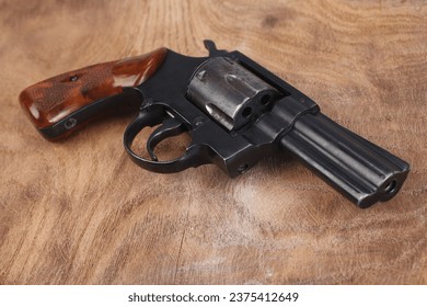 Revolver on wooden table background