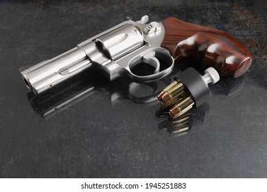 Revolver Pistol Handgun And Bullets  On Texture Background