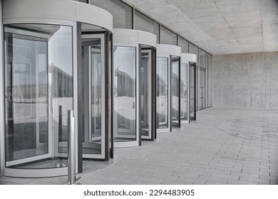 Revolving doors. The facade of a modern shopping center or station, an airport with revolving doors.