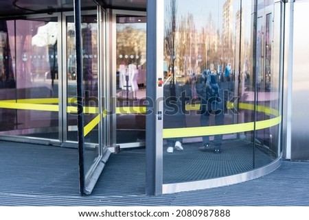 Revolving glass door on modern corporate building