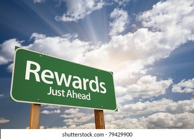 Rewards Green Road Sign Against Clouds and Sunburst. - Shutterstock ID 79429900