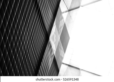 Reworked modern architecture photo featuring spacious empty area for text placement. Abstract business interior in minimalism or hi-tech design. Tilt black-and-white photo with checkered wall panels.