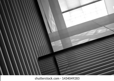 Reworked Photo Of Sloped Walls With Louvered Structure. Fragments Of Hi-tech Industrial Or Office Building Interior With Striped Pattern. Abstract Modern Architecture Background In Black And White.