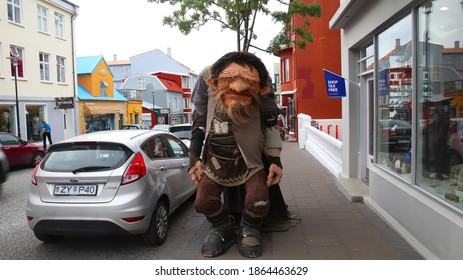 Reykjavick, Iceland - May 22, 2017: A life-size troll stands on the sidewalk in front of an Icelandic souvenir shop.
