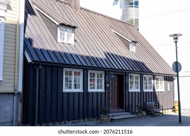 Reykjavik, Iceland - June 12 2021: A Black, Traditional Wooden House  In Downtown. Empty Street, No People. Sunny Day.
