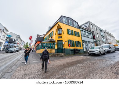 Reykjavik, Iceland - June 19, 2018: Street Road In Downtown Center And Yellow Colorful Building Sign For Primo Restaurant Exterior And People Walking Crossing