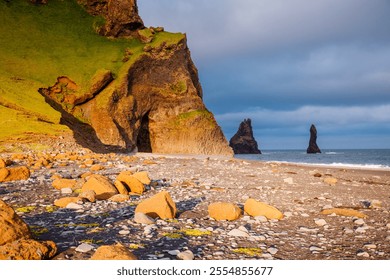 Reynisdrangar basalt sea stacks (Troll toes) and the rugged cliffs on the Reynisfjara black sand beach. Location place Vik I Myrdal, southern Iceland, Europe. Discovery the beauty of earth. - Powered by Shutterstock