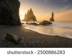 Reynisfjara black sand beach in Iceland, near town of Vik, at sunrise, beautiful basalt rock formation