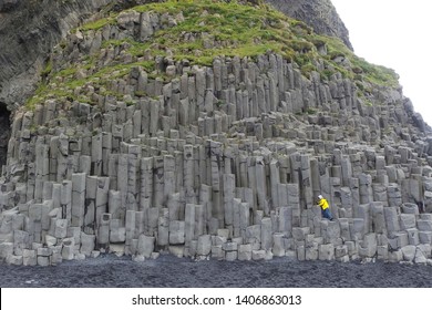 Reynisfjara - Famous Black Beach With Interesting Rock Formations On South Iceland And Small Climbing Child