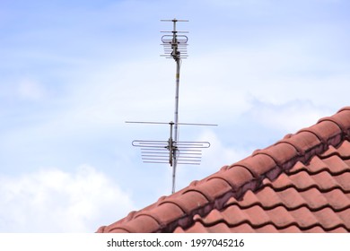 RF Antenna On The Roof Top With White Cloud On The Background.