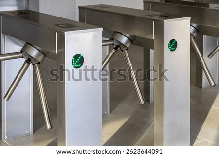 RFID card access control system on modern stainless steel turnstile gate in smart office building, contactless security entrance, workplace access, biometric ID, secure entry technology