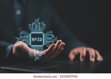 RFID, Radio Frequency Identification concept. Electronic data storage system that enhances computational capabilities and data security. Man with RFID technology on virtual screen.