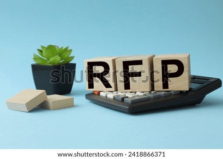 RFP Request For Proposal. text on wooden blocks. cubes on a calculator