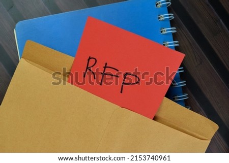 RFP - Request For Proposal write on sticky notes isolated on Wooden Table.