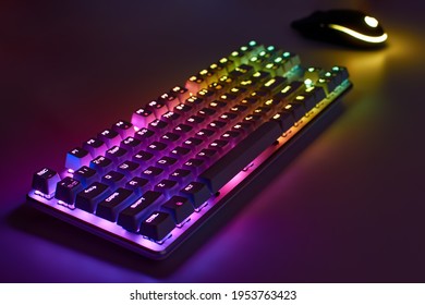 RGB gaming keyboard. Bright colorful keyboard with mouse, neon light. Mechanical keyboard with RGB light.