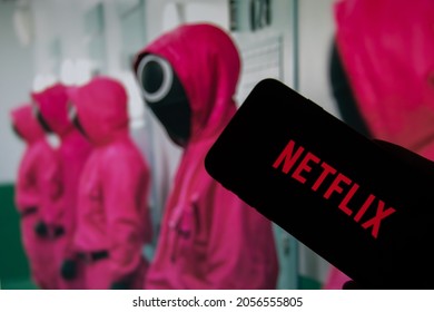 Rheinbach, Germany  12 October 2021,  
The Netflix logo on the display of a smartphone in front of a television with the new series "Squid Game" ( focus on Netflix logo )