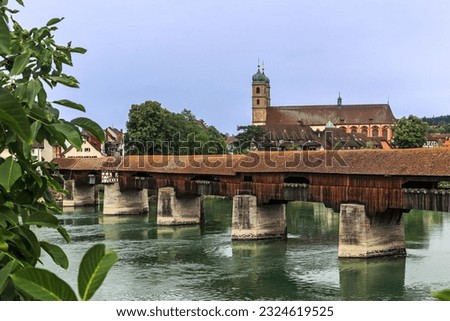 The Rhine with the historic wood bridge and Fridolins munster in Bad Saeckingen at summer, Germany