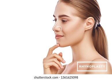 Rhinoplasty - nose surgery. Side view of attractive young woman with perfect skin and dotted lines on her nose isolated on white background. Plastic surgery concept