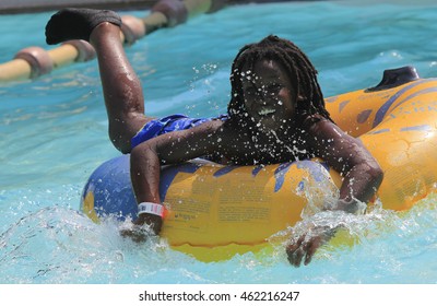 Rhodes, Greece-July 31,2016:The black boy after rafting slide in the  Water park.Rafting slide is one of many popular game for adults and children in park.Water Park is located on the island of Rhodes