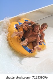 Rhodes, Greece-September 2,2017:Young Couple Drive With Tube On The Rafting Slide In The  Water Park.Rafting Slide Is One Of Many Popular Games For Adults And Children In Park.