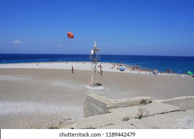 Rhodes: Sept 2, 2018 - Parasailing Water Amusement. Flying On A Parachute Behind A Boat On A Summer Holiday By The Sea