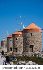 Rhodes Windmills In Mandraki Harbor A Place Frequently Visited By Tourists.