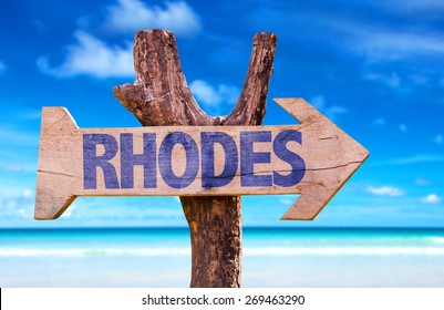 Rhodes Wooden Sign With Beach Background