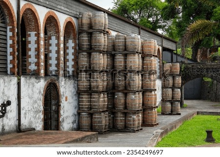 rhum casks in front of a distillery warehouse 