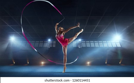 Rhythmic gymnast in professional arena. - Powered by Shutterstock