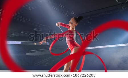 Rhythmic gymnast in professional arena.