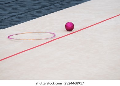 Rhythmic Gymnastics hoop and ball on the side of the competition floor, spare apparatus during competition - Powered by Shutterstock