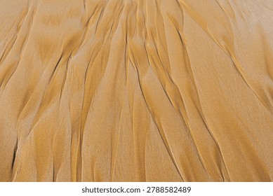 Rhythmic sand ripples create a hypnotic geometric pattern. Parallel lines and soft shadows enhance the tactile organic texture of this minimalist desert landscape view.