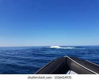 Rib Boat On Calm Blue Sea With Old Buildings And Majestic Mountains On The Helgeland Coast In Northern Norway